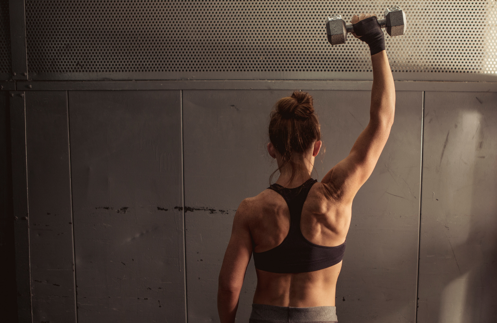 woman lifting a weight with a shoulder
