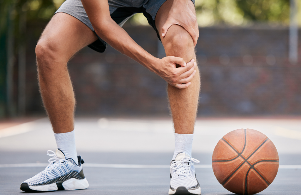 basketball player clutching sore knee