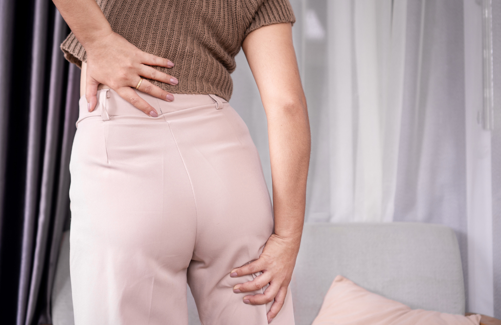 women holding her leg in pain due to sciatica