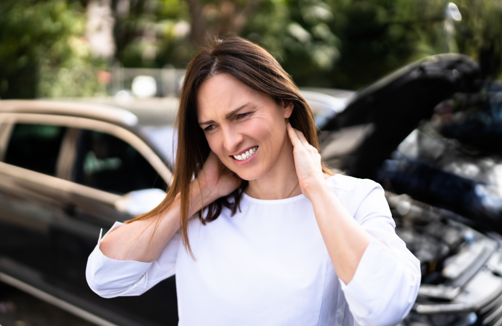 woman with whiplash holding sore neck