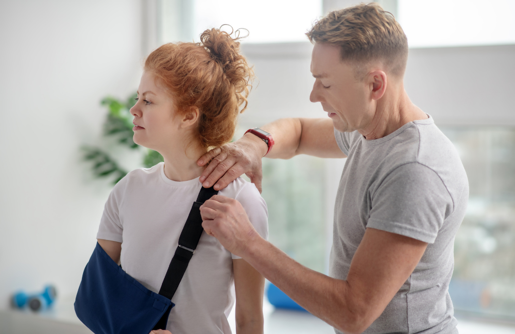 physio assessing a patient in a sling