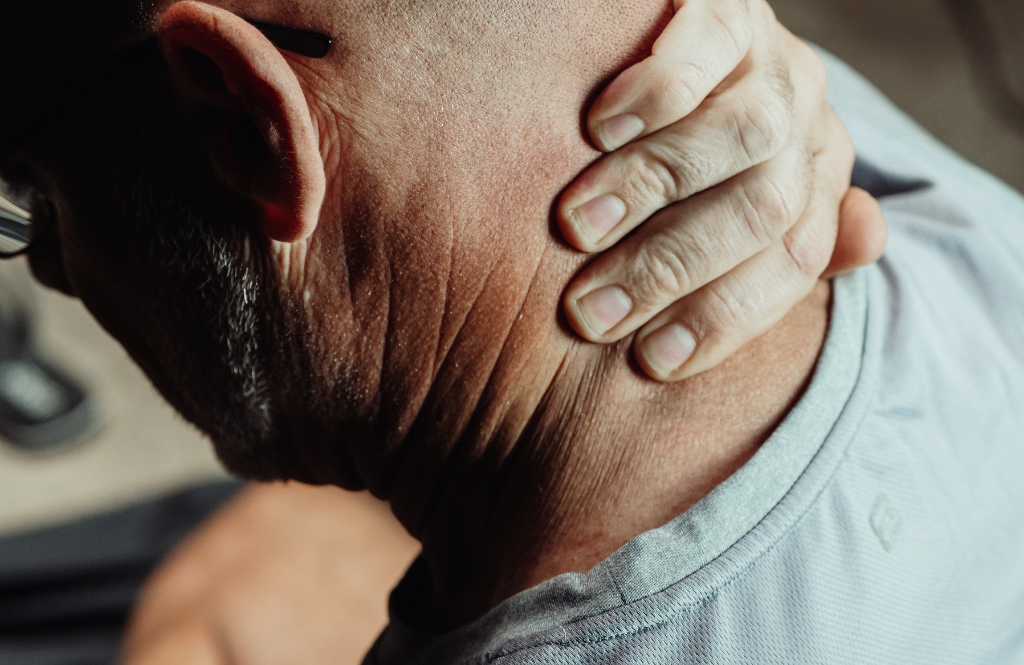 man holding his neck in pain