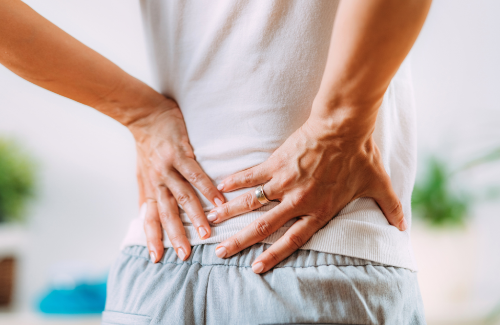 a woman holding her sore lower back