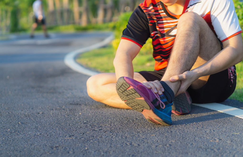 man holding a rolled ankle ligament sprain
