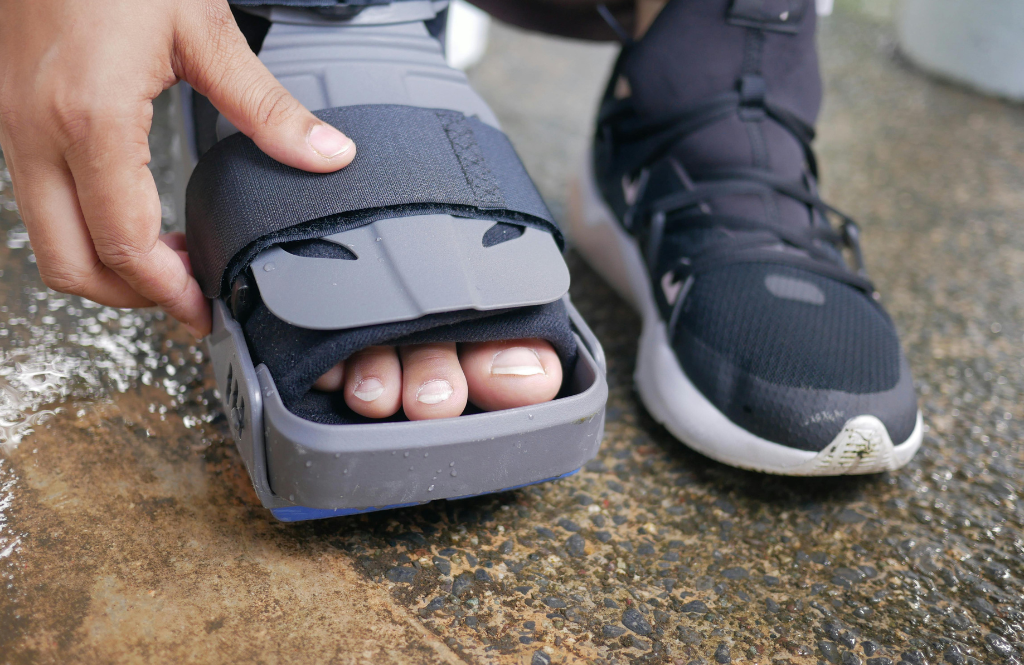 person in a walker boot after foot surgery